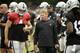Oakland Raiders head coach Jon Gruden talks with quarterback Derek Carr during NFL football practice Wednesday, Aug. 8, 2018, in Napa, Calif. Both the Oakland Raiders and the Detroit Lions held a joint practice before their upcoming preseason game on Friday. (AP Photo/Eric Risberg)