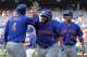 New York Mets' Jose Bautista, center, high-fives Wilmer Flores after Bautista hit a grand slam during the fifth inning of a baseball game against the Philadelphia Phillies, Thursday, Aug. 16, 2018, in Philadelphia. (AP Photo/Tom Mihalek)
