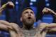 Conor McGregor poses on the scale during a weigh-in Friday, Aug. 25, 2017, in Las Vegas for his Saturday boxing bout against Floyd Mayweather Jr. (AP Photo/John Locher)
