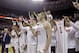 Texas players flash the