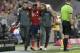 Bayern's Kingsley Coman leaves injured the field during the German Bundesliga soccer match between FC Bayern Munich and TSG 1899 Hoffenheim in Munich, Germany, Friday, Aug. 24, 2018. (AP Photo/Matthias Schrader)