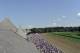 Race fans watch the second race prior to the Travers Stakes horse race at Saratoga Race Course in Saratoga Springs, N.Y., Saturday, Aug. 27, 2016. (AP Photo/Hans Pennink)