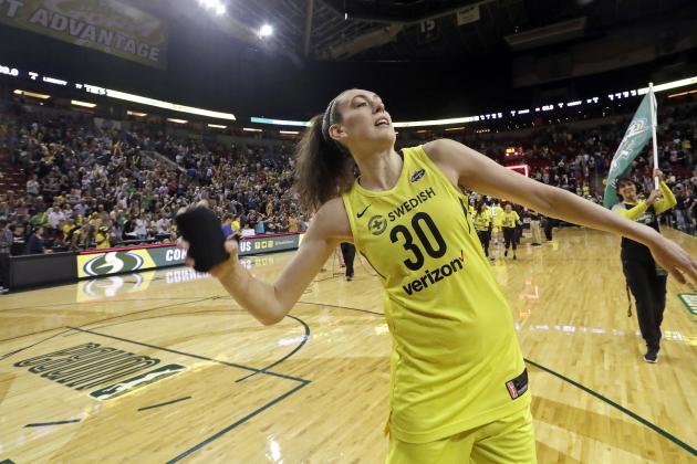 FILE - In this Aug. 17, 2018, file photo, Seattle Storm's Breanna Stewart tosses a T-shirt to fans after the Storm's 85-77 win over the New York Liberty in a WNBA basketball game, in Seattle. Stewart has taken her game to a new level this year to lead Seattle to the top spot in the league.  Her efforts earned her Associated Press WNBA Player of the Year honors on Tuesday, Aug. 21, 2018. (AP Photo/Elaine Thompson, File)