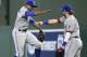 Toronto Blue Jays' Curtis Granderson, left, and Josh Donaldson celebrate the team's 8-5 victory over the Texas Rangers in a baseball game Friday, April 6, 2018, in Arlington, Texas. (AP Photo/Jeffrey McWhorter)