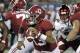 Alabama quarterback Tua Tagovailoa (13) scrambles while looking for a receiver against Louisville during the first half of an NCAA college football game, Saturday, Sept. 1, 2018, in Orlando, Fla. (AP Photo/John Raoux)