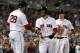 Boston Red Sox's Mookie Betts smiles as he is greeted by J.D. Martinez after scoring from first on a three-run double by Andrew Benintendi during the fourth inning of a baseball game against the Cleveland Indians on Wednesday, Aug. 22, 2018, in Boston. (AP Photo/Winslow Townson)