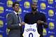 Golden State Warriors General Manager Bob Myers, left, holds a jersey with DeMarcus Cousins during a media conference Thursday, July 19, 2018, in Oakland, Calif. Cousins signed a one-year, $5.3M deal with the defending champion Warriors. (AP Photo/Ben Margot)