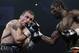 Georgia's Avtandil Khurtsidze, left, fights against Hassan N'Dam of France, during their WBA middleweight boxing world championship bout at Palais des Sports in Paris, Saturday Oct. 30, 2010. The 26-year-old N'Dam, a Cameroon-born fighter recently granted French citizenship, received winning scores of 117-111, 115-114 and 115-114 from the judges to improve to 25-0, and became the interim WBA champion. Kazakhstan's Gennady Golovkin is the recognized titleholder. (AP Photo/Francois Mori)