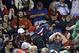 Fans react after getting hit by a bat, which flew over the protective screening, after Toronto Blue Jays's Devon Travis lost his grip on a swing during the eighth inning of a baseball game against the Boston Red Sox at Fenway Park in Boston, Wednesday, Sept. 12, 2018. (AP Photo/Charles Krupa)