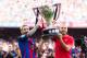 BARCELONA, SPAIN - AUGUST 20: Lionel Messi (L) and Andres Iniesta (R) of FC Barcelona lift up the Spanish La Liga 2015-2016 season trophy before the La Liga match between FC Barcelona and Real Betis Balompie at Camp Nou on August 20, 2016 in Barcelona, Spain. (Photo by Alex Caparros/Getty Images)