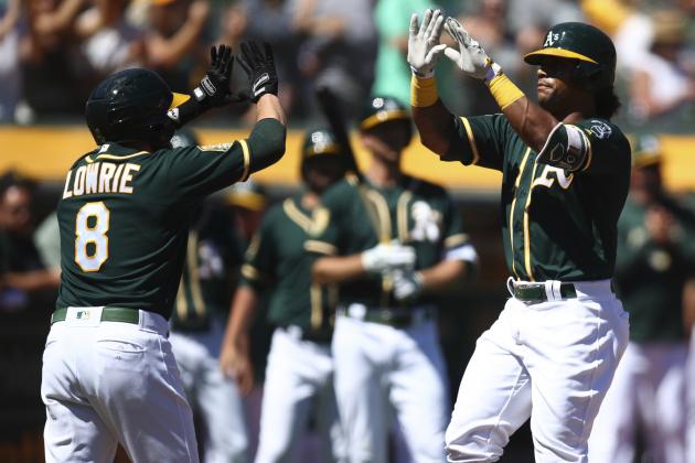 Oakland Athletics' Khris Davis, right, celebrates with Jed Lowrie (8) after hitting a two-run home run off Texas Rangers' Yohander Mendez in the first inning of a baseball game Saturday, Sept. 8, 2018, in Oakland, Calif. (AP Photo/Ben Margot)