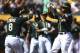 Oakland Athletics' Khris Davis, right, celebrates with Jed Lowrie (8) after hitting a two-run home run off Texas Rangers' Yohander Mendez in the first inning of a baseball game Saturday, Sept. 8, 2018, in Oakland, Calif. (AP Photo/Ben Margot)