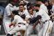 Atlanta Braves second baseman Ozzie Albies (1) is mobbed by his teammates after hitting a walk-off home run in the 11th inning of a baseball game against the Cincinnati Reds, Tuesday, June 26, 2018, in Atlanta. (AP photo/John Bazemore)