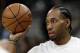 FILE - In this Jan. 5, 2018, file photo, San Antonio Spurs forward Kawhi Leonard handles a ball before an NBA basketball game against the Phoenix Suns in San Antonio. Two people familiar with the situation say San Antonio and Toronto have reached an agreement in principle on a trade that will send Kawhi Leonard to the Raptors and DeMar DeRozan to the Spurs. One of the people says the Spurs also are sending Danny Green to the Raptors as part of the deal. Both people spoke to The Associated Press on condition of anonymity Wednesday, July 18, 2018, because the deal has not been finalized. (AP Photo/Eric Gay, File)