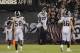 Los Angeles Rams cornerback Marcus Peters (22) celebrates in the end zone after making a 50-yard interception for a touchdown during the second half of an NFL football game against the Oakland Raiders in Oakland, Calif., Monday, Sept. 10, 2018. Los Angeles won the game 33-13. Looking on are the Rams' Cory Littleton (58) and Matt Longacre (96). (AP Photo/John Hefti)