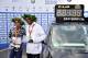 Winner Kenya's Eliud Kipchoge (R) and women's winner Kenya's Gladys Cherono pose with their trophies and medals next to a clock displaying Kipchoge's winning time setting a new record after the Berlin Marathon on September 16, 2018 in Berlin. (Photo by John MACDOUGALL / AFP) (Photo credit should read JOHN MACDOUGALL/AFP/Getty Images)