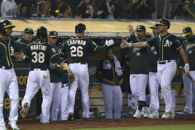 Oakland Athletics' Matt Chapman (26) and Nick Martini (38) are congratulated after scoring against the Los Angeles Angels during the fourth inning of a baseball game Wednesday, Sept. 19, 2018, in Oakland, Calif. (AP Photo/Ben Margot)