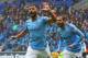 Manchester City's Argentinian striker Sergio Aguero (L) celebrate after scoring the opening goal of the English Premier League football match between between Cardiff City and Manchester City at Cardiff City Stadium in Cardiff, south Wales on September 22, 2018. (Photo by Geoff CADDICK / AFP) / RESTRICTED TO EDITORIAL USE. No use with unauthorized audio, video, data, fixture lists, club/league logos or 'live' services. Online in-match use limited to 120 images. An additional 40 images may be used in extra time. No video emulation. Social media in-match use limited to 120 images. An additional 40 images may be used in extra time. No use in betting publications, games or single club/league/player publications. / (Photo credit should read GEOFF CADDICK/AFP/Getty Images)