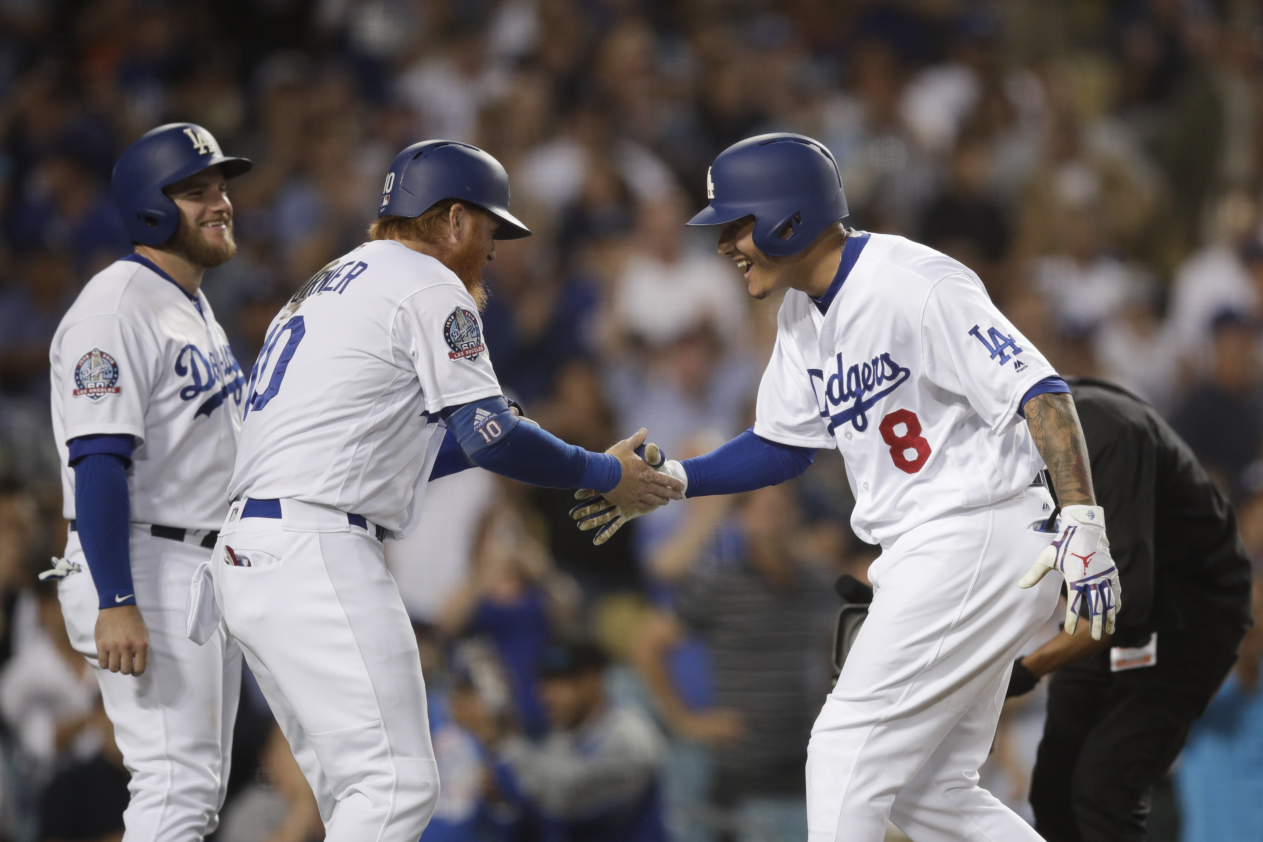 Los Angeles Dodgers' Manny Machado, right, celebrates his three-run home run with Justin Turner and Max Muncy, left, during the third inning of a baseball game against the San Diego Padres, Saturday, Sept. 22, 2018, in Los Angeles. (AP Photo/Jae C. Hong)