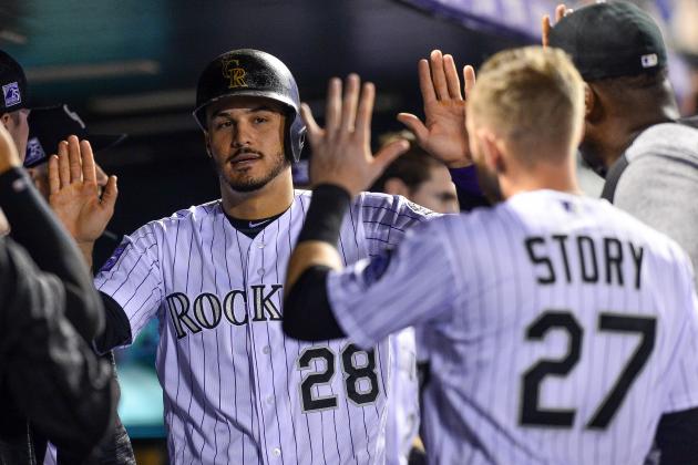 DENVER, CO - SEPTEMBER 24:  Nolan Arenado #28 of the Colorado Rockies is congratulated in the dugout by Trevor Story #27 after scoring a run in the third inning of a game against the Philadelphia Phillies at Coors Field on September 24, 2018 in Denver, Colorado.  (Photo by Dustin Bradford/Getty Images)