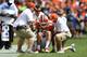 CLEMSON, SC - SEPTEMBER 29: Quarterback Trevor Lawrence #16 of the Clemson Tigers is helped from the field after taking a hard hit from the Syracuse Orange during the football game at Clemson Memorial Stadium on September 29, 2018 in Clemson, South Carolina. (Photo by Mike Comer/Getty Images)