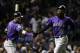 Colorado Rockies' Charlie Blackmon, right, celebrates with Trevor Story after scoring on a sacrifice fly by Nolan Arenado during the first inning of the National League wild-card playoff baseball game against the Chicago Cubs, Tuesday, Oct. 2, 2018, in Chicago. (AP Photo/Nam Y. Huh)