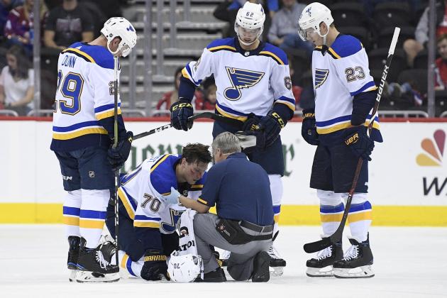 FILE - In this Sept. 30, 2018, file photo, St. Louis Blues center Oskar Sundqvist (70), of Sweden, is tended to by a trainer after he was checked by Washington Capitals right wing Tom Wilson, not seen, during the second period of an NHL preseason hockey game,in Washington. Also seen are Blues defenseman Vince Dunn (29), St. Louis Blues left wing Mackenzie MacEachern (62) and St. Louis Blues right wing Dmitrij Jaskin (23), of Russia. Wilson has been suspended 20 games by the NHL for a blindside hit to the head of an opponent during a preseason game. Wilson's punishment was announced Wednesday, Oct. 3, 2018, just hours before the reigning Stanley Cup champion Capitals were to raise their banner and open their title defense by hosting the Boston Bruins to begin the regular season. (AP Photo/Nick Wass, File)