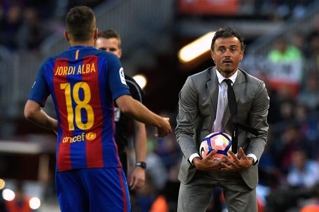 Barcelona's coach Luis Enrique (R) gives a ball to Barcelona's defender Jordi Alba during the Spanish league football match FC Barcelona vs SD Eibar at the Camp Nou stadium in Barcelona on May 21, 2017. / AFP PHOTO / LLUIS GENE        (Photo credit should read LLUIS GENE/AFP/Getty Images)