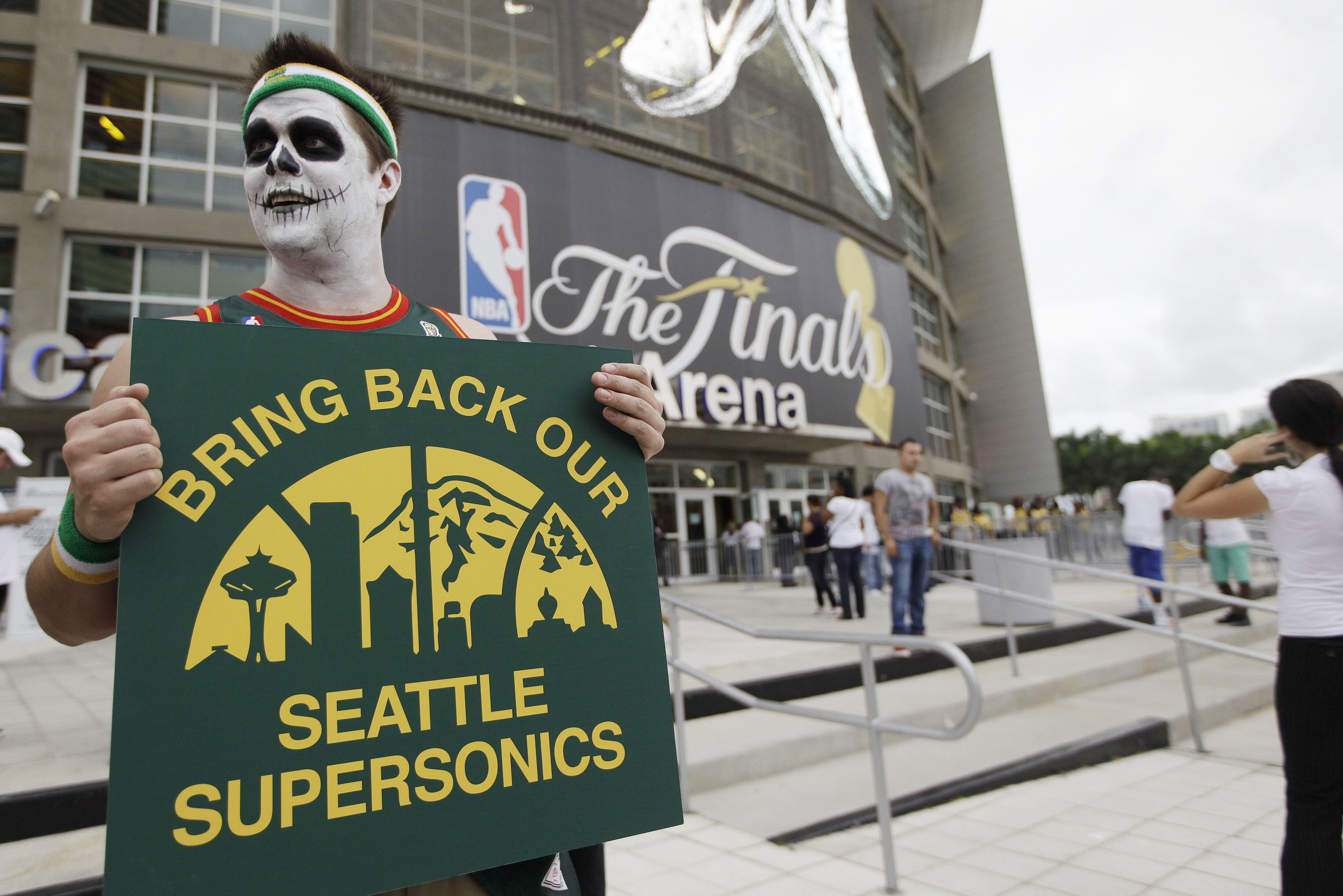 Seattle Supersonics fan Colin Baxter demonstrates before Game 4 of the NBA finals basketball series between the Oklahoma City Thunder and the Miami Heat, Tuesday, June 19, 2012, in Miami.  The Thunder used to be the Supersonics.(AP Photo/Lynne Sladky)