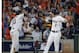 Houston Astros' Alex Bregman (2) celebrates his solo home run with teammate Yuli Gurriel (10) as Cleveland Indians catcher Yan Gomes, center, looks on during the fourth inning in Game 1 of an American League Division Series baseball game against the Cleveland Indians, Friday, Oct. 5, 2018, in Houston. (AP Photo/David J. Phillip)