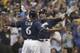 Milwaukee Brewers' Christian Yelich celebrates his two-run home run with Lorenzo Cain during the third inning of Game 1 of the National League Divisional Series baseball game against the Colorado Rockies Thursday, Oct. 4, 2018, in Milwaukee. (AP Photo/Morry Gash)
