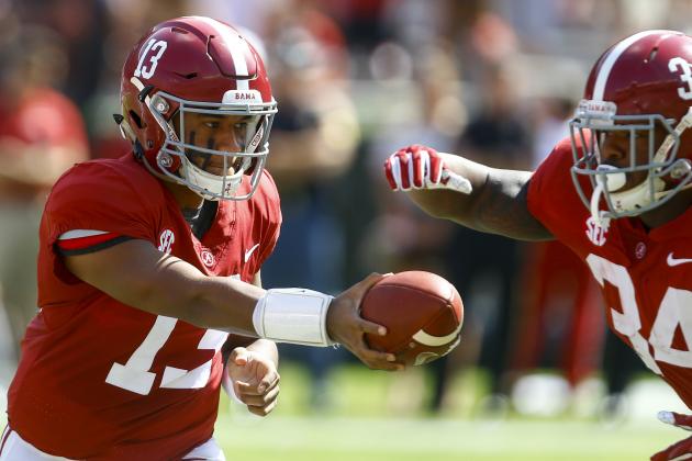 Alabama quarterback Tua Tagovailoa (13) hands off to running back Damien Harris (34) during the first half of an NCAA college football game against Louisiana-Lafayette, Saturday, Sept. 29, 2018, in Tuscaloosa, Ala. (AP Photo/Butch Dill)