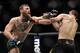 LAS VEGAS, NV - OCTOBER 06: (L-R) Conor McGregor of Ireland punches Khabib Nurmagomedov of Russia in their UFC lightweight championship bout during the UFC 229 event inside T-Mobile Arena on October 6, 2018 in Las Vegas, Nevada. (Photo by Brandon Magnus/Zuffa LLC/Zuffa LLC via Getty Images)