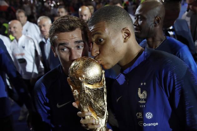 France's Kylian Mbappe, right, and and Antoine Griezmann kiss the World Cup trophy during a ceremony following the UEFA Nations League soccer match between France and The Netherlands at the Stade de France stadium in Saint-Denis, outside Paris, France, Sunday, Sept. 9, 2018. (AP Photo/Christophe Ena)