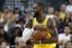 Los Angeles Lakers forward LeBron James reacts after a play against the Golden State Warriors during the first half of an NBA preseason basketball game Wednesday, Oct. 10, 2018, in Las Vegas. (AP Photo/John Locher)