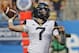 West Virginia's Will Grier (7) looks to pass against Tennessee in the first half of an NCAA college football game in Charlotte, N.C., Saturday, Sept. 1, 2018. (AP Photo/Chuck Burton)