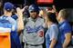 ATLANTA, GA - OCTOBER 07: Chris Taylor #3 of the Los Angeles Dodgers celebrates in the dugout after hitting a two-run home run in the fifth inning against the Atlanta Braves during Game Three of the National League Division Series at SunTrust Park on October 7, 2018 in Atlanta, Georgia. (Photo by Rob Carr/Getty Images)