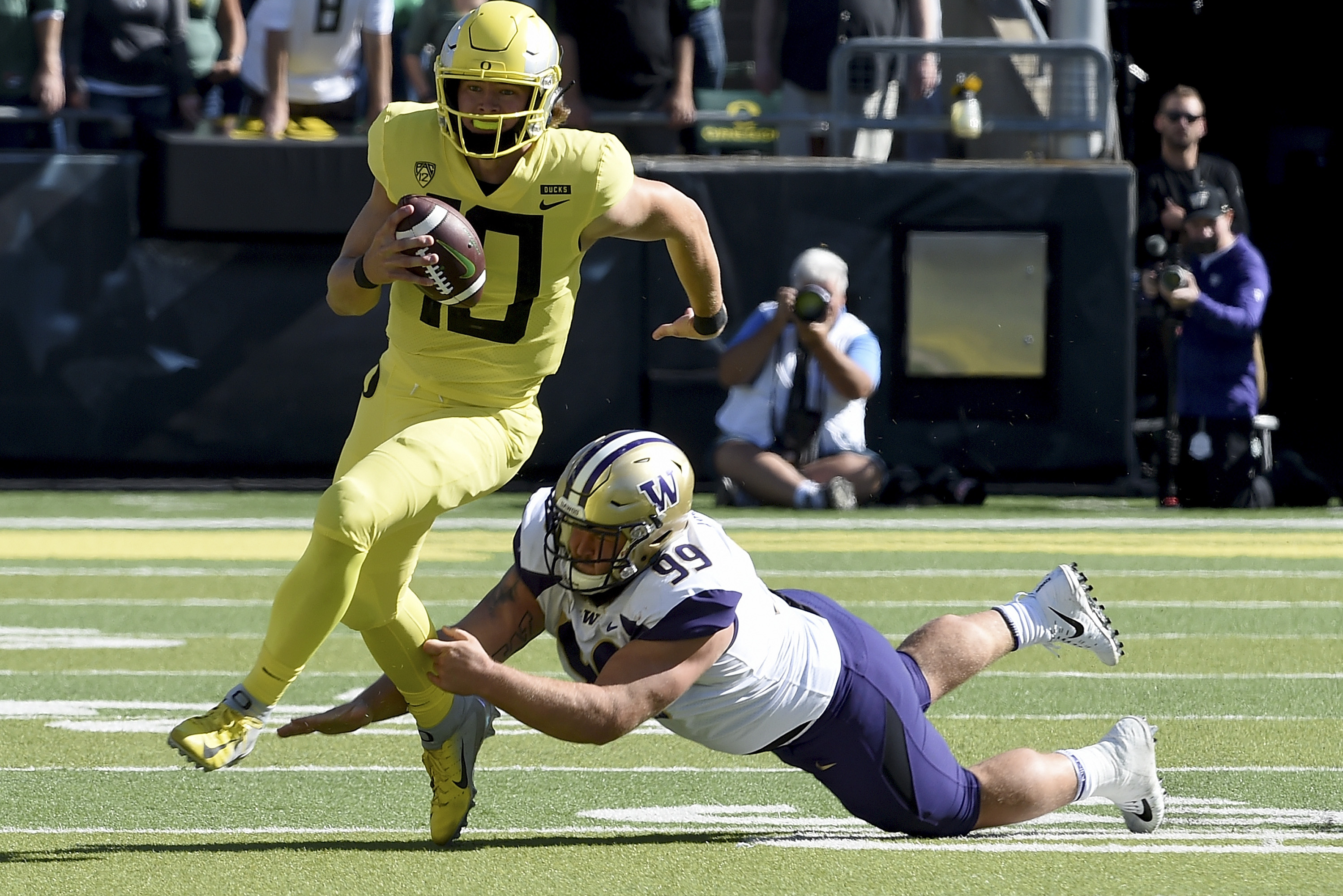 Justin Herbert Oregon Ducks Unsigned Yellow Jersey Running with Ball vs.  Arizona State Photograph