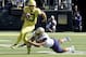 EUGENE, OR - OCTOBER 13: Quarterback Justin Herbert #10 of the Oregon Ducks scrambles against defensive lineman Greg Gaines #99 of the Washington Huskies in the first half of the game at Autzen Stadium on October 13, 2018 in Eugene, Oregon. (Photo by Steve Dykes/Getty Images)