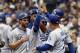 MILWAUKEE, WI - OCTOBER 13: Justin Turner #10 of the Los Angeles Dodgers celebrates with his teammates after hitting a two run home run against Jeremy Jeffress #32 of the Milwaukee Brewers during the eighth inning in Game Two of the National League Championship Series at Miller Park on October 13, 2018 in Milwaukee, Wisconsin. (Photo by Rob Carr/Getty Images)
