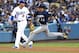 LOS ANGELES, CA - JULY 31: Christian Yelich #22 of the Milwaukee Brewers rounds the bases on his way to scoring a run on a double off the bat of Lorenzo Cain of the Milwaukee Brewers as Manny Machado #8 of the Los Angeles Dodgers looks on in the third inning against the Los Angeles Dodgers at Dodger Stadium on July 31, 2018 in Los Angeles, California. (Photo by Jayne Kamin-Oncea/Getty Images)