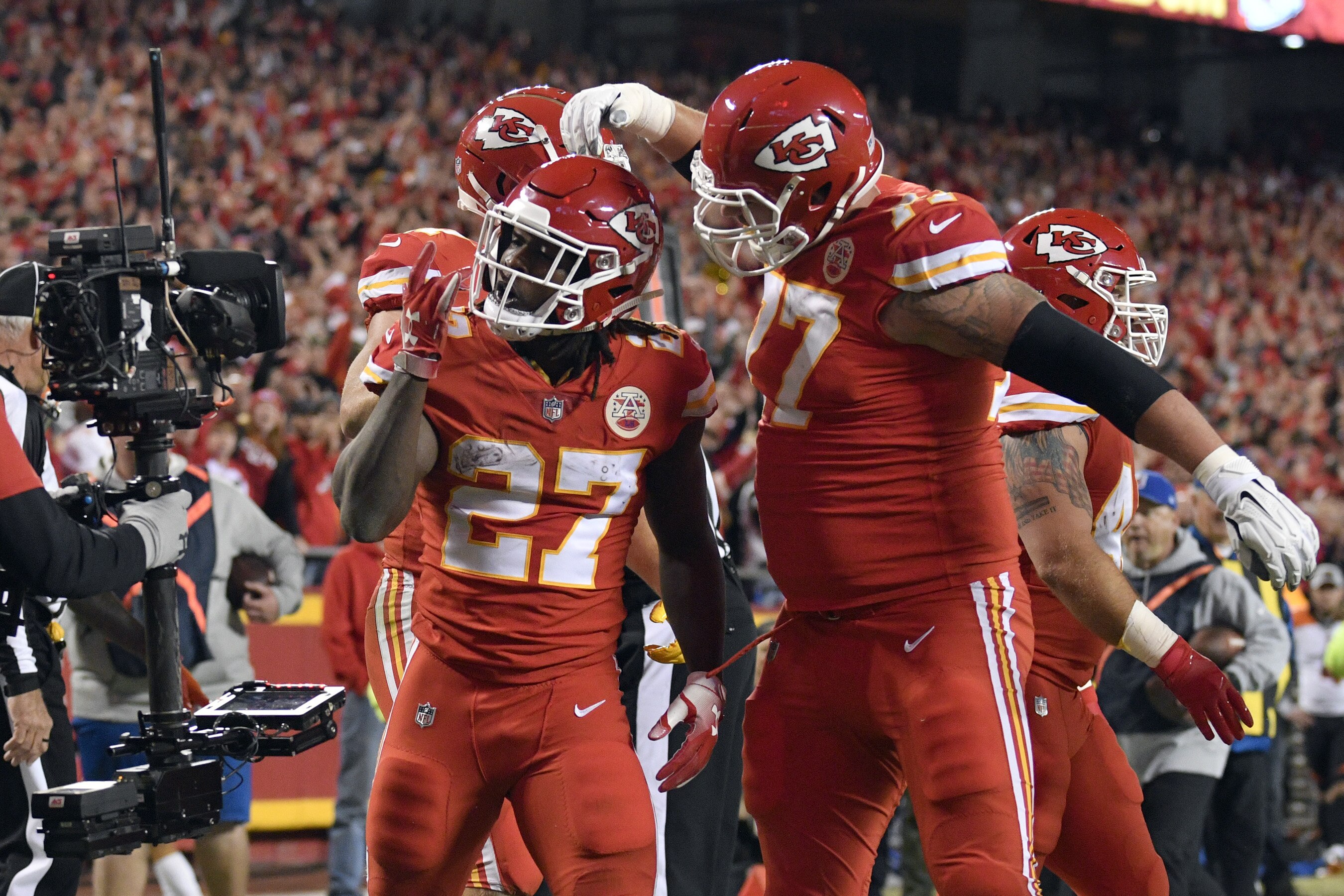Kansas City Chiefs running back Kareem Hunt (27) celebrates a touchdown with offensive lineman Andrew Wylie (77) during the first half of an NFL football game against the Cincinnati Bengals in Kansas City, Mo., Sunday, Oct. 21, 2018. (AP Photo/Ed Zurga)