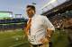 Miami head coach Al Golden runs onto the field after his team defeated Virginia Tech 30-20 in an NCAA college football game, Saturday, Oct. 17, 2015, in Miami Gardens, Fla. (AP Photo/Joe Skipper)