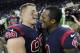 Houston Texans defensive end J.J. Watt (99) and quarterback Deshaun Watson (4) celebrate their win over Miami Dolphins in an NFL football game, Thursday, Oct. 25, 2018, in Houston. (AP Photo/Eric Christian Smith)