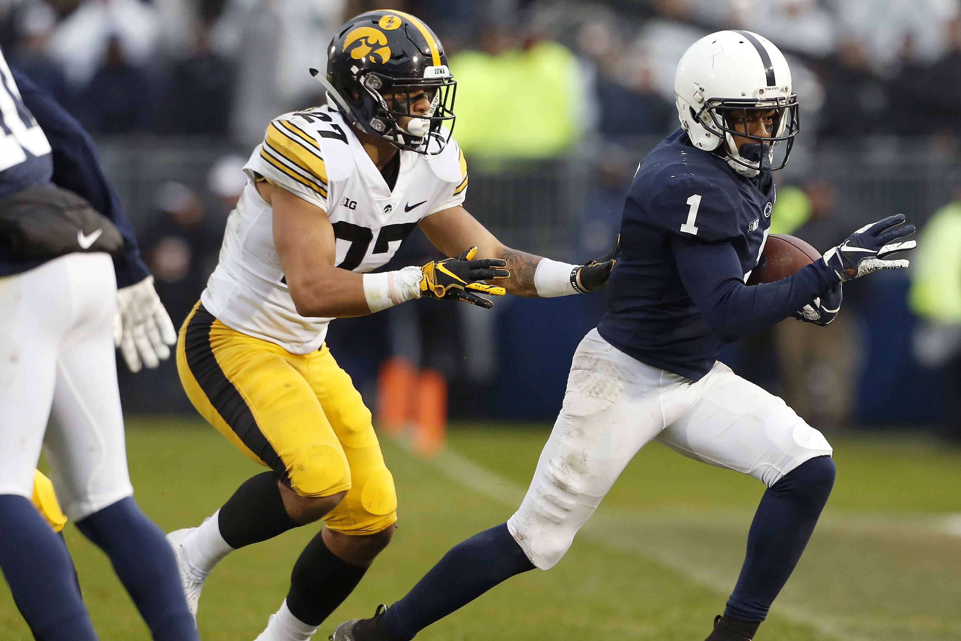 Penn State's KJ Hamler (1) runs out of bounds after a catch as Iowa's Amani Hooker (27) defends during the first half of an NCAA college football game in State College, Pa., Saturday, Oct. 27, 2018. (AP Photo/Chris Knight)