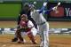 Los Angeles Dodgers' Manny Machado hits a single in front of Boston Red Sox catcher Christian Vazquez during the fourth inning in Game 2 of the World Series baseball game Wednesday, Oct. 24, 2018, in Boston. (AP Photo/Elise Amendola)