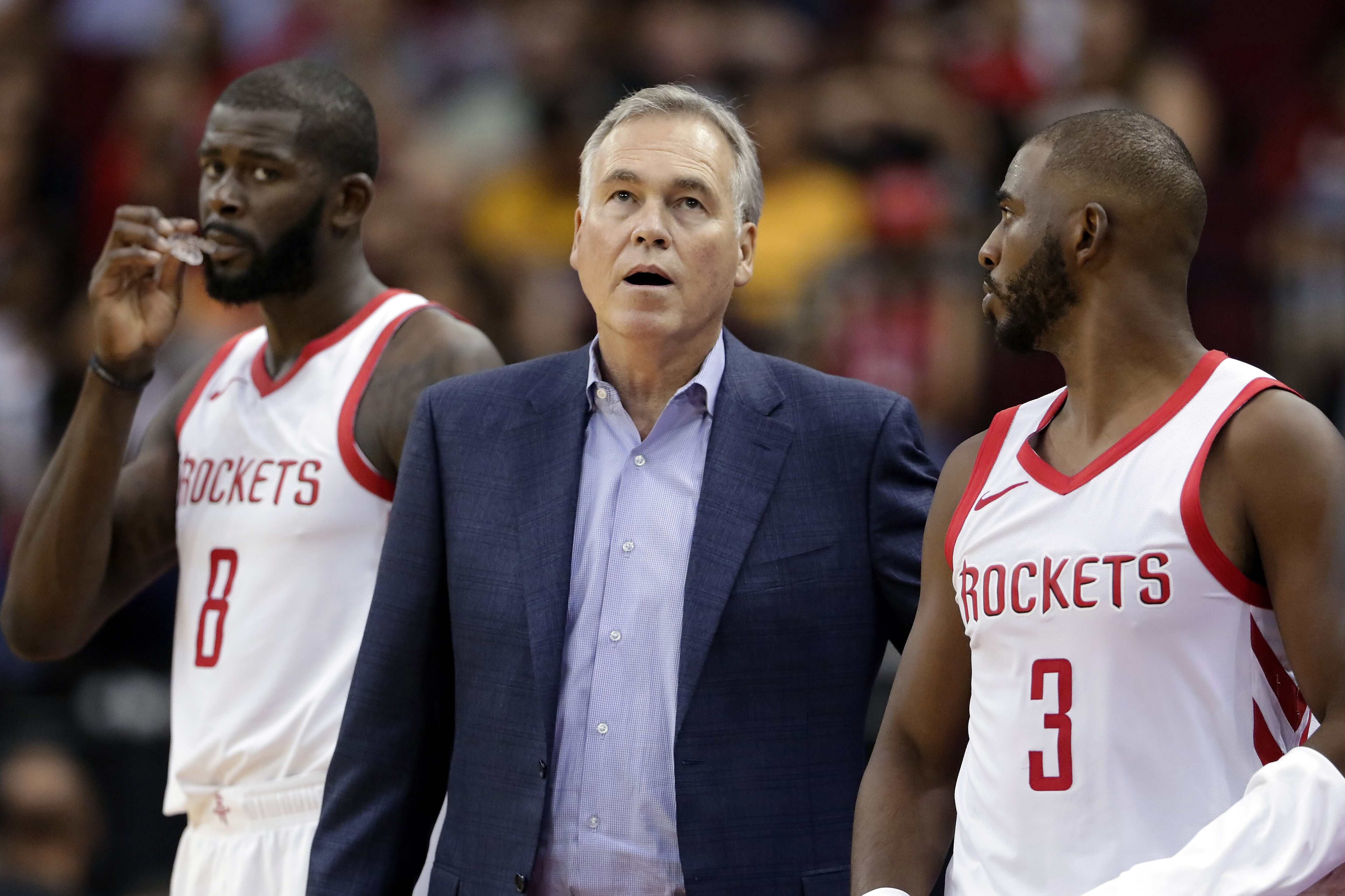 Houston Rockets coach Mike D'Antoni checks the scoreboard as he stands between players James Ennis III (8) and Chris Paul (3) during the second half of the team's NBA basketball preseason game against the Indiana Pacers on Thursday, Oct. 4, 2018, in Houston. (AP Photo/Michael Wyke)