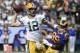 Green Bay Packers quarterback Aaron Rodgers (12) throws a pass under pressure from Los Angeles Rams defensive tackle Aaron Donald (99) during the first half of an NFL football game, Sunday, Oct. 28, 2018, in Los Angeles. (AP Photo/Denis Poroy)