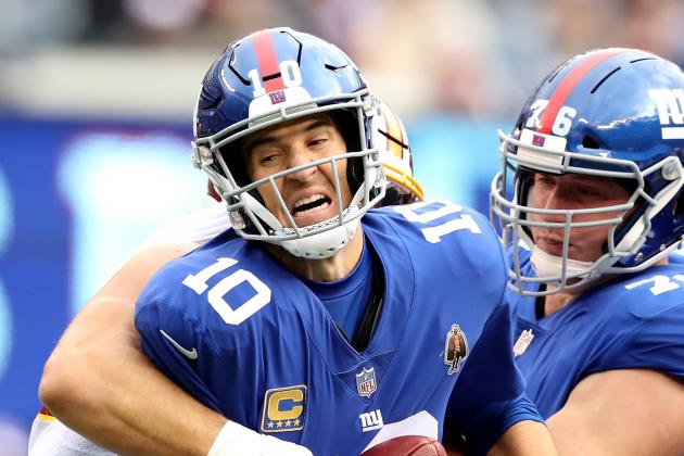 EAST RUTHERFORD, NJ - OCTOBER 28:  Eli Manning #10 of the New York Giants is sacked against the Washington Redskins on October 28,2018 at MetLife Stadium in East Rutherford, New Jersey.  (Photo by Elsa/Getty Images)