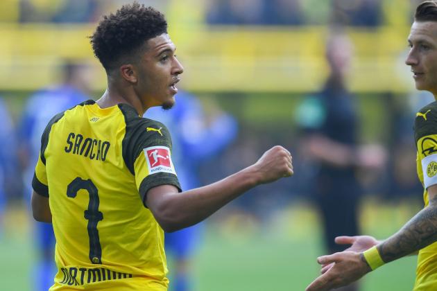 Dortmund's English midfielder Jadon Sancho celebrates scoring the opening goal with Dortmund's German forward Marco Reus during the German first division Bundesliga football match BVB Borussia Dortmund v Hertha Berlin in Dortmund, western Germany, on October 27, 2018. (Photo by Patrik STOLLARZ / AFP) / RESTRICTIONS: DFL REGULATIONS PROHIBIT ANY USE OF PHOTOGRAPHS AS IMAGE SEQUENCES AND/OR QUASI-VIDEO        (Photo credit should read PATRIK STOLLARZ/AFP/Getty Images)